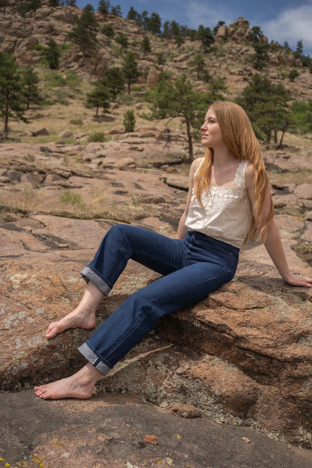 Woman wearing the Helene Selvedge Jeans sewing pattern from Anna Allen on The Fold Line. A jeans pattern made in selvedge denim, non-stretch denim, drill, cotton canvas, twill or corduroy fabrics, featuring a high waist, two front scoop pockets, coin pock