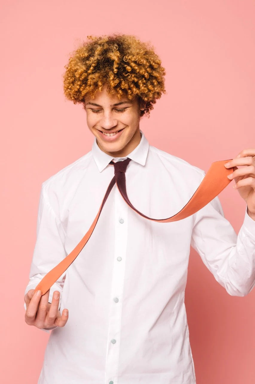 Photo of a man wearing the Henrik Tie sewing pattern from Melilot on The Fold Line. A tie pattern made in cotton, wool, silk or rayon fabrics, featuring a reversible design and narrow silhouette.