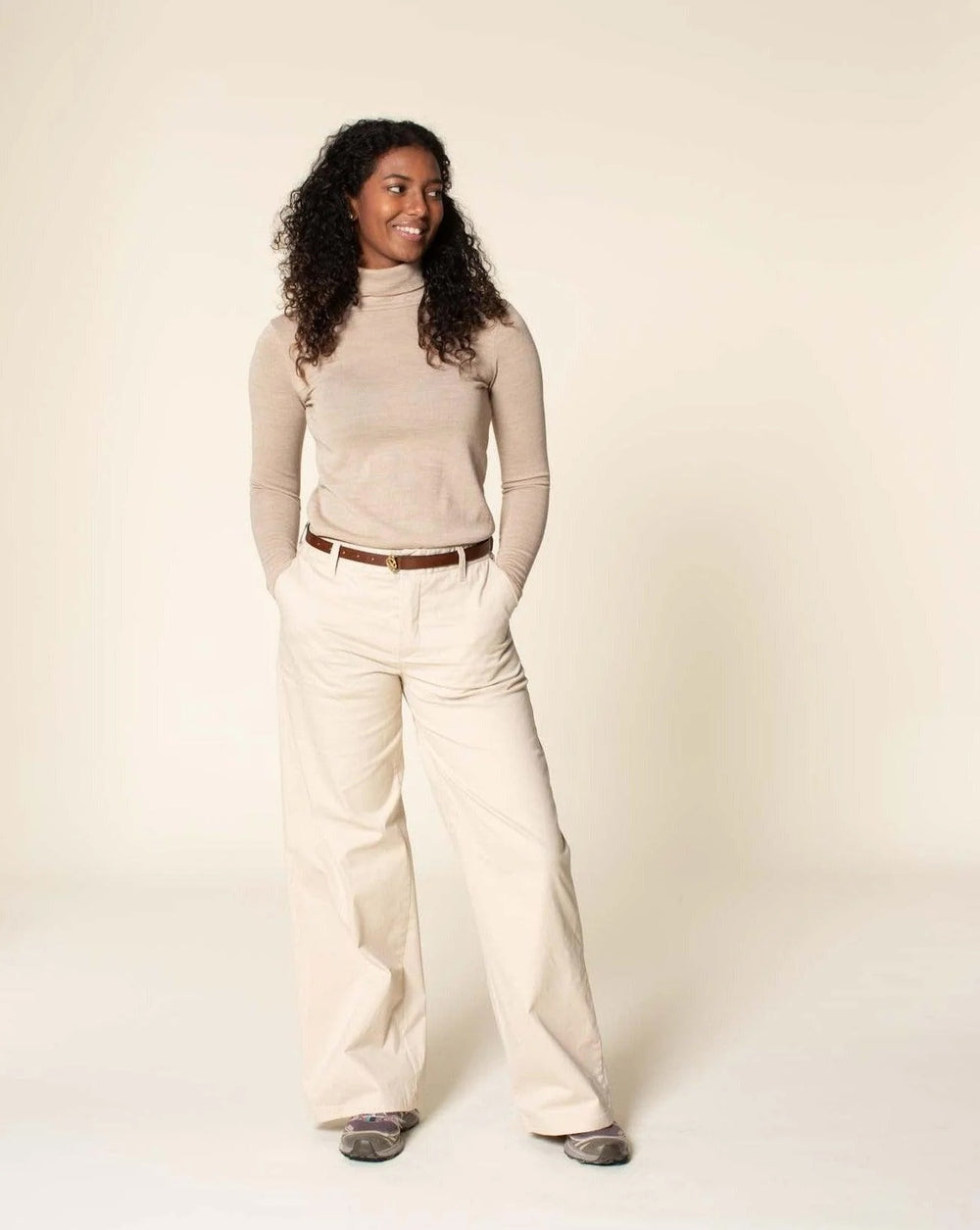 Woman wearing the Hepburn Pants sewing pattern from Wardrobe by Me on The Fold Line. A trouser pattern made in cotton, linen, canvas or denim fabrics, featuring a front zip fly, side pockets, back welt pockets, waistband with five belt loops and wide legs