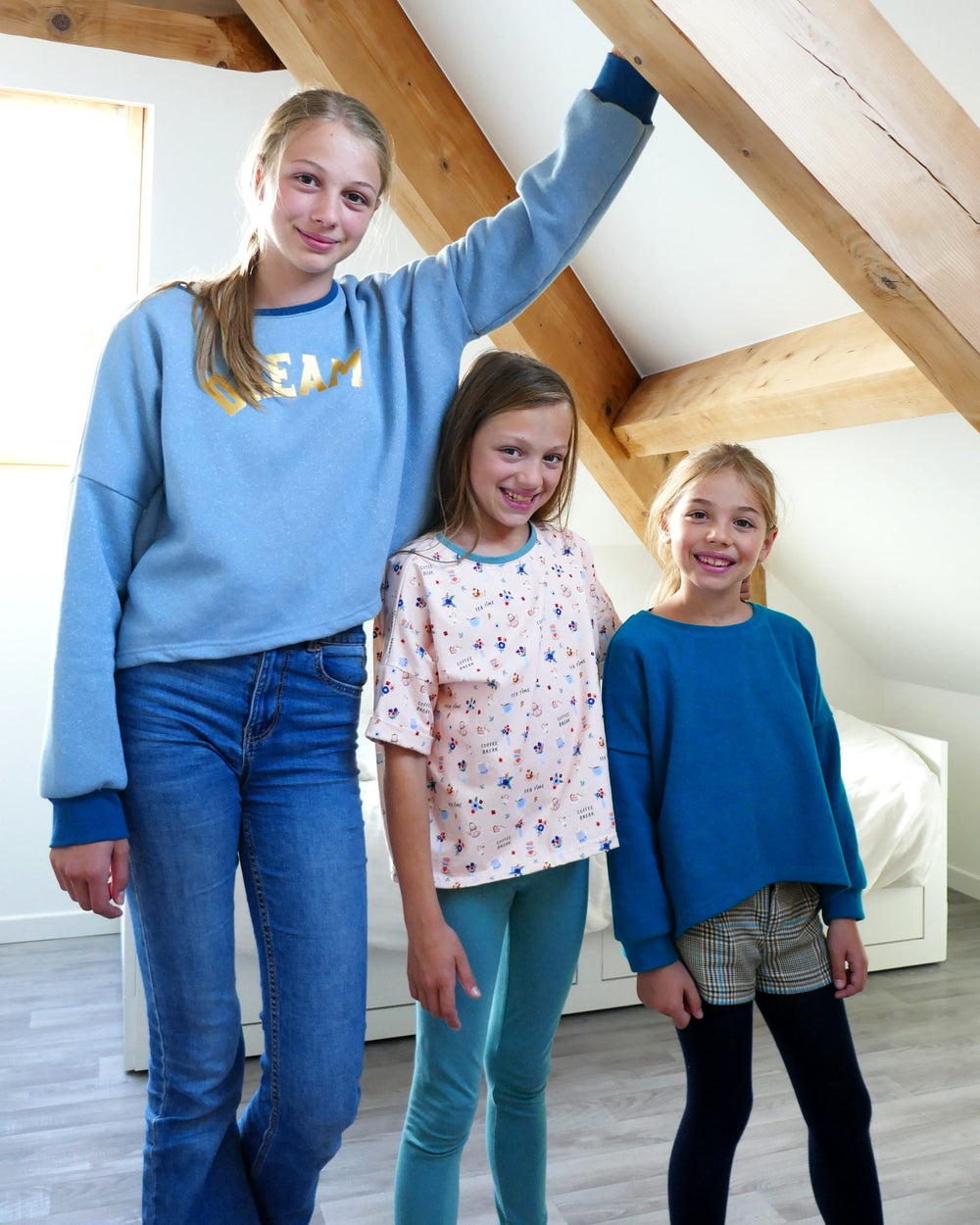 Children wearing the Child/Teen Hoony T-shirt or Sweatshirt sewing pattern from Petits D’om on The Fold Line. A T-shirt or sweatshirt pattern made in Jersey fabrics, featuring an oversized top with wide body, round neckline, three hem options, dropped sho