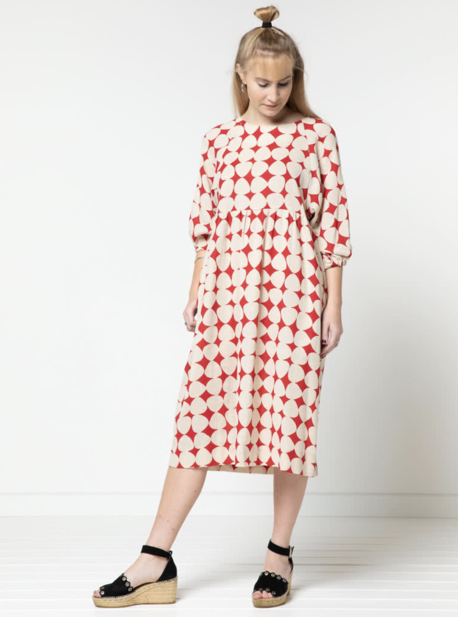 Woman wearing the Hope Woven Dress sewing pattern from Style Arc on The Fold Line. A dress pattern made in washed linen, rayon, crepe, cotton or knit fabrics, featuring a relaxed fit, slip on style, high waist, round neck, 7/8 length deep raglan sleeve wi