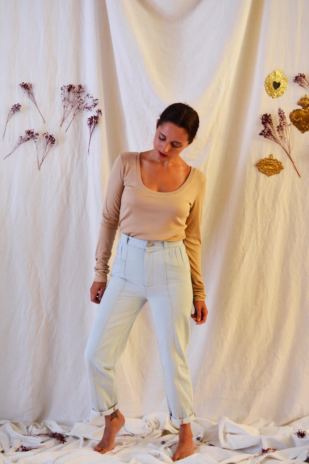 Woman wearing the Hussard Jeans sewing pattern from Maison Fauve on The Fold Line. A trouser pattern made in denim, wool suiting, cotton twill or jacquard fabrics, featuring a high waist, hip hugging, tapered leg, back patch pockets, front pockets, pleat 