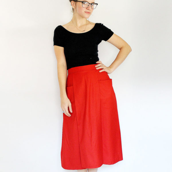 Woman wearing the Patti Pocket Skirt sewing pattern by Amy Nicole. A skirt pattern made in medium to heavy weight woven fabrics such as denim, twill, brocade, linen, quilting cotton and suiting fabrics, featuring a combination pleated and flared skirt wit