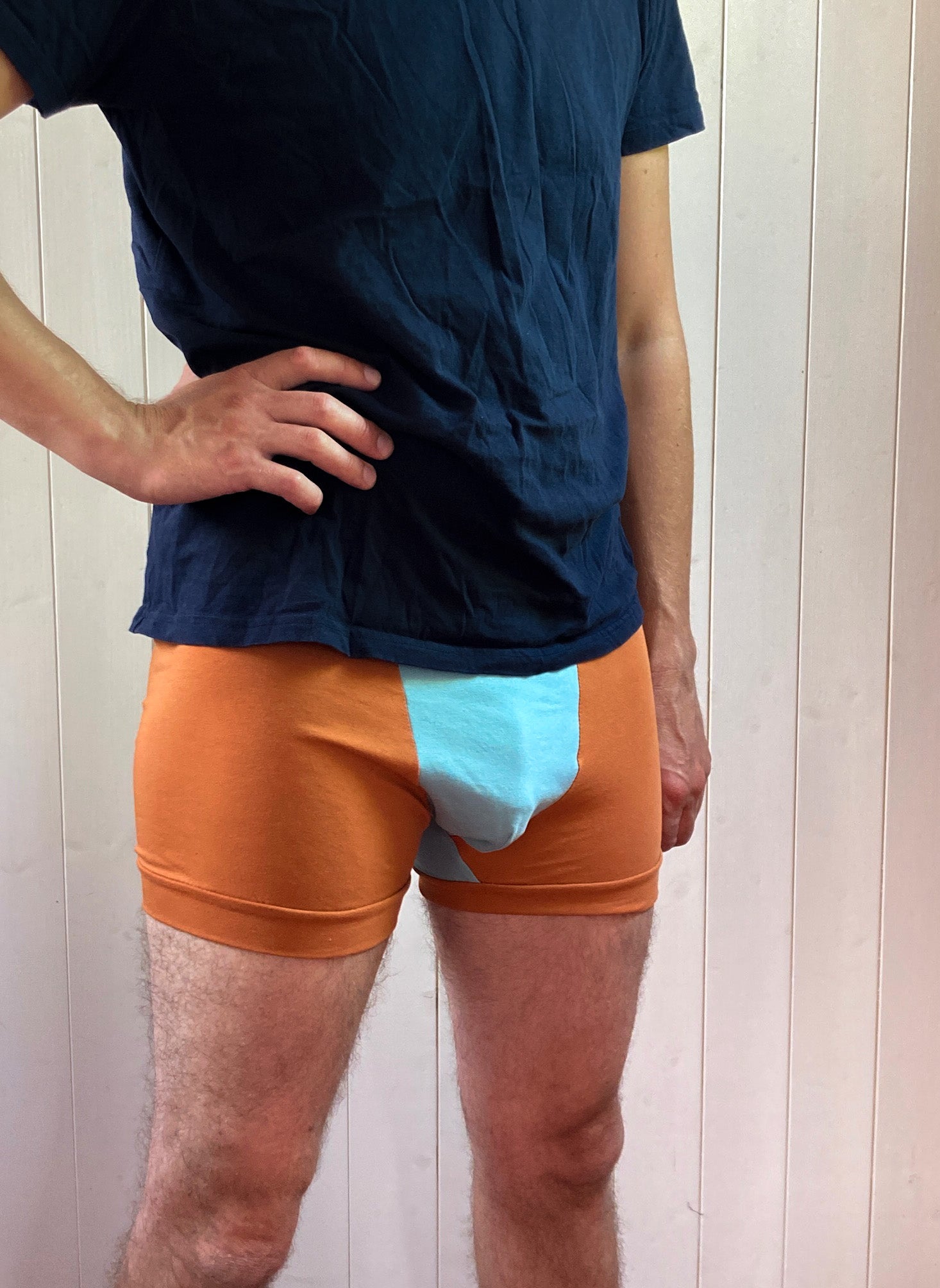 Man wearing the Men's Indigo Boxer Briefs sewing pattern from Sew Projects on The Fold Line. A Boxer Brief pattern made in cotton jersey, bamboo jersey or nylon/poly/lycra jersey fabrics, featuring a panelled design, colour blocking and designed to sit be