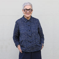 Woman wearing the Ines Shirt sewing pattern by Tessuti Fabrics. A shirt pattern made in cotton, linen, firm silk such as dupion or taffeta fabrics, featuring a hip length, button front closure, slightly flared silhouette, patch pocket, back yoke with cent