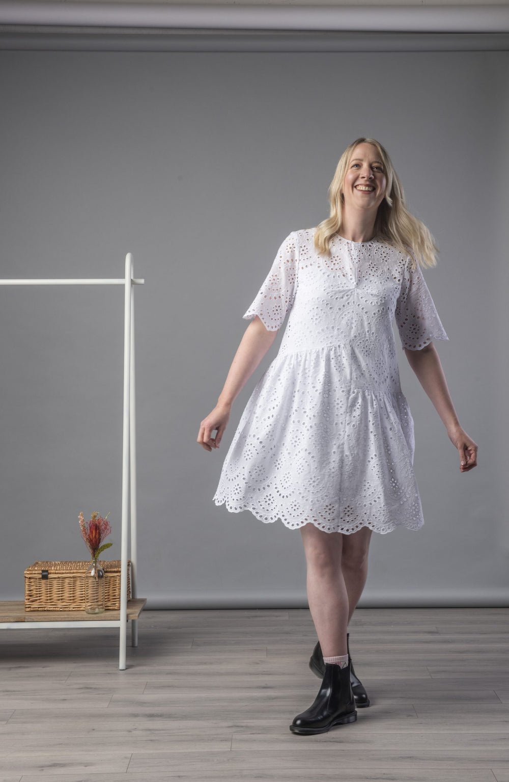 Woman wearing the Ingrid Dress sewing pattern by Homer and Howells. A gathered panel dress pattern made in cotton lawn, poplin, linen, chambray, taffeta or fine cords fabrics, featuring asymmetric seams, centre front bust tuck, back button and loop closur