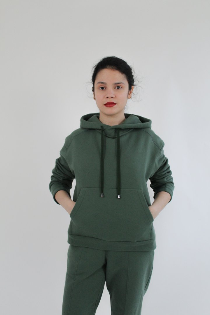 Woman wearing the Interstellar Hoodie sewing pattern from Bella Loves Patterns on The Fold Line. A hoodie pattern made in sweatshirting, French terry, Ponte Roma or cotton fleece fabrics, featuring a moderate oversized fit, angled shoulder yoke, two-piece