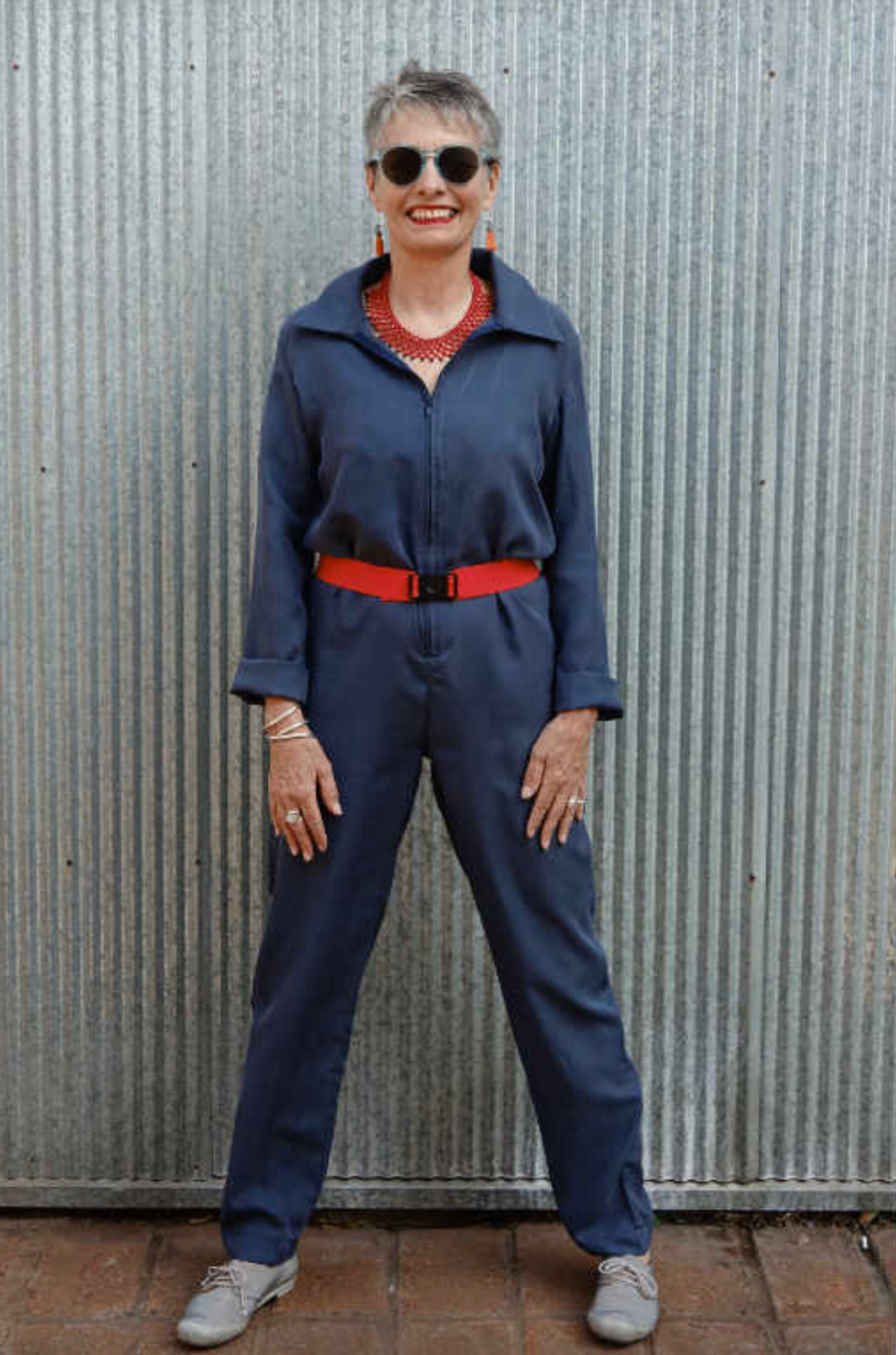 Woman wearing the Intrepid Boiler Suit sewing pattern by Alice and Co Patterns. A boiler suit pattern made in light-weight denim or cotton twill, light wool or wool mix, heavy-weight silk or polyester crepe fabrics, featuring a classic shirt collar and sl