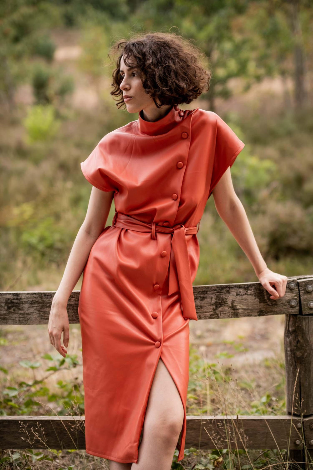 Woman wearing the Irene Dress sewing pattern from Fibre Mood on The Fold Line. A dress pattern made in flannel, lyocell, poplin, chambray, (checked) wool, gabardine, linen, viscose or leather (faux) fabrics, featuring a straight dress, standing collar, as