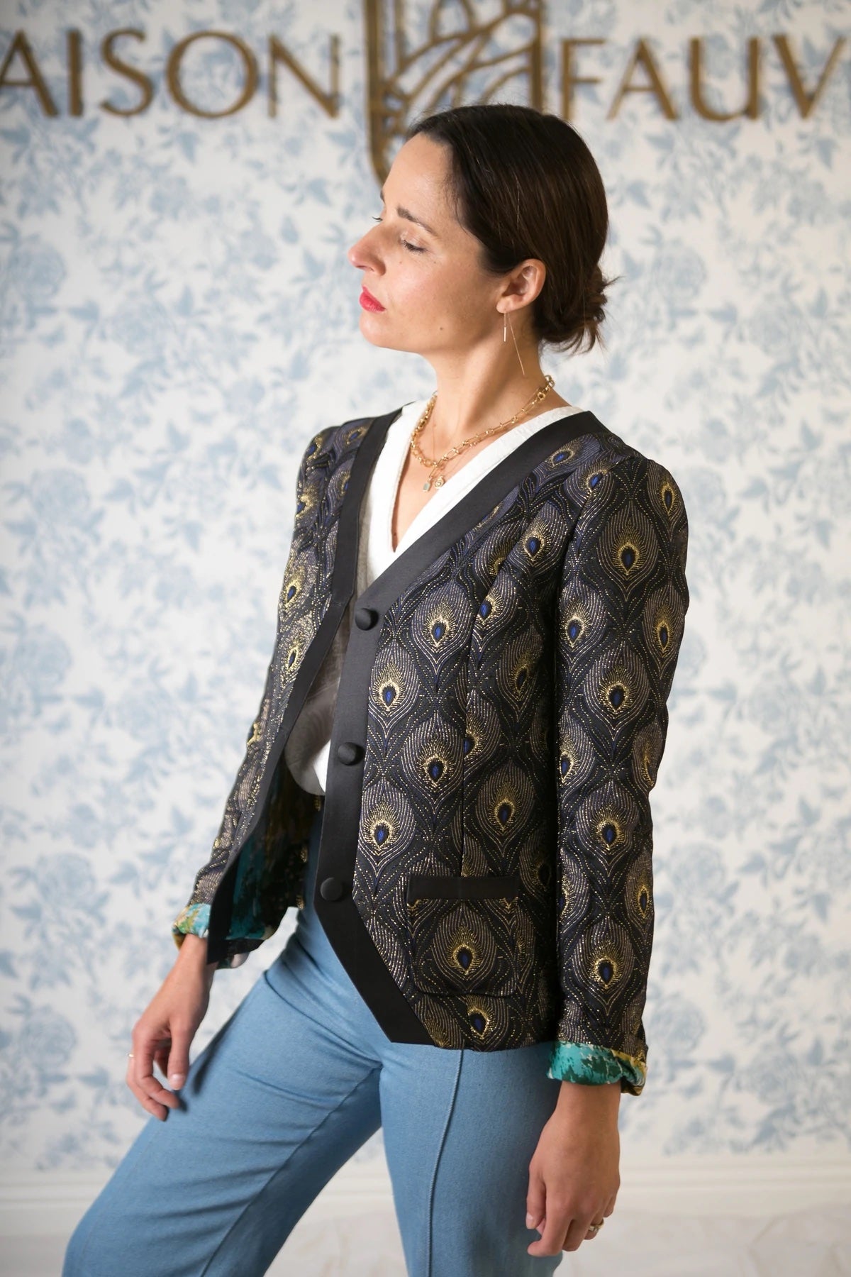 Woman wearing the Ispahan Jacket sewing pattern from Maison Fauve on The Fold Line. A fitted, collarless jacket pattern made in jacquard, gabardine, denim, velvet or fine woollen fabrics, featuring patch pockets, contrasting band, full length sleeves, 3 b