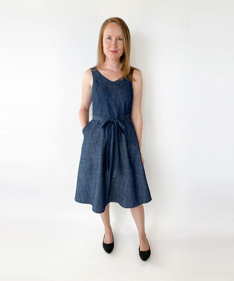 Woman wearing the Jade Wrap Dress sewing pattern from Jennifer Lauren Handmade on The Fold Line. A wrap dress pattern made in linen, chambray, denim, seersucker, jacquard, tencel, wool, suitings or pinwale cord fabrics, featuring a fit-and-flare style, ba