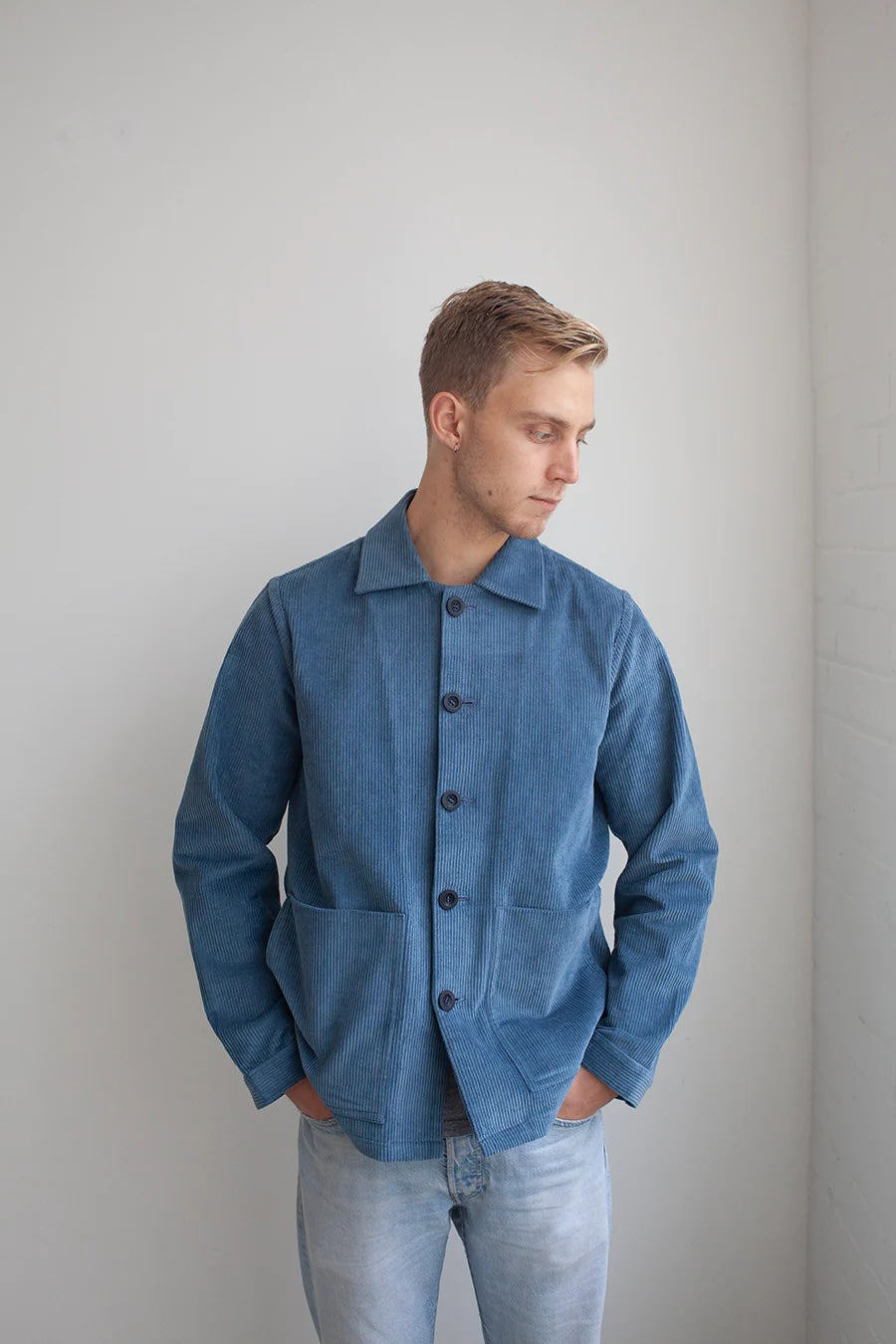 Man wearing the Men's Jaime Jacket sewing pattern from The Modern Sewing Co. on The Fold Line. A jacket pattern made in denim, corduroy, twill/drill/gabardine, heavy linen/hemp, thin wool and waxed cotton fabrics, featuring a curved back yoke front patch 