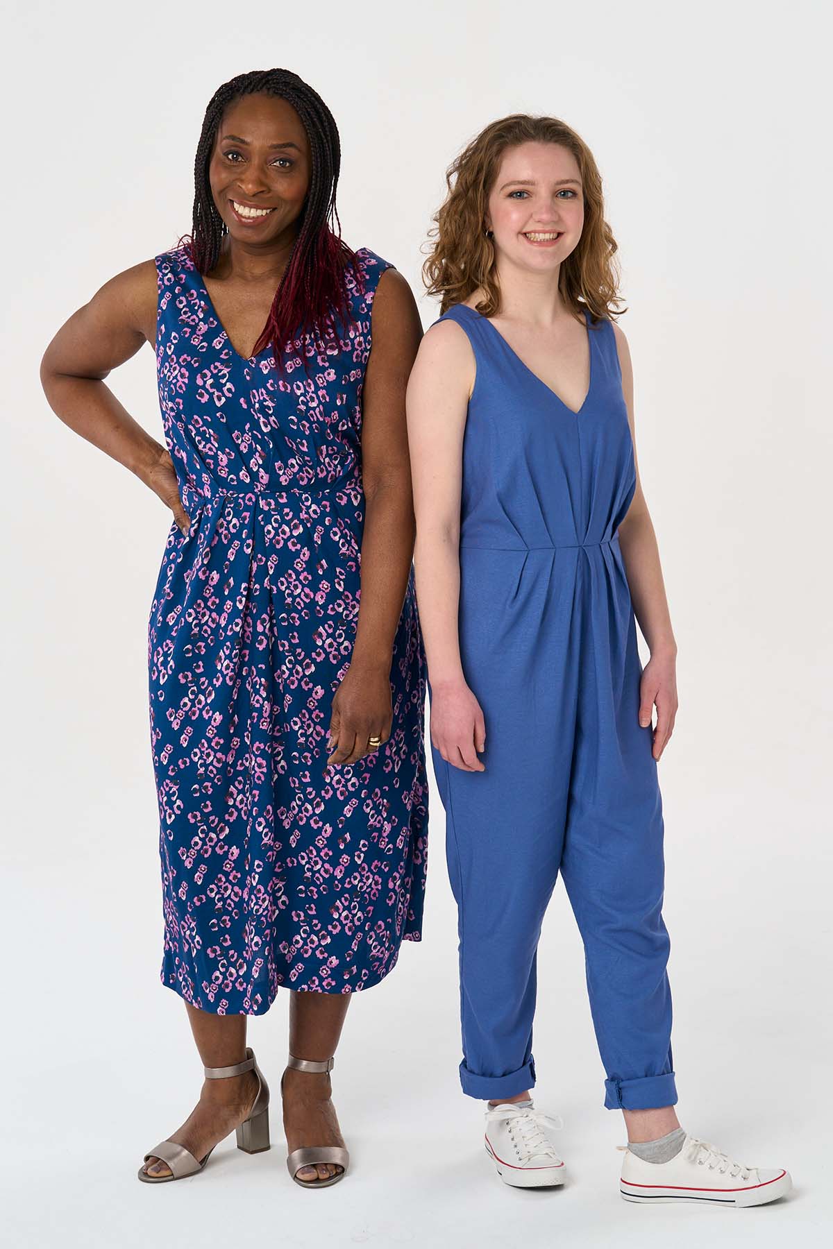 Women wearing the Jemima Jumpsuit and Dress sewing pattern from Sew Over It on The Fold Line. A jumpsuit and dress pattern made in rayon, viscose or crepe fabrics, featuring a front and back V-neck, wide bra-covering straps, front waist pleats, narrow ela