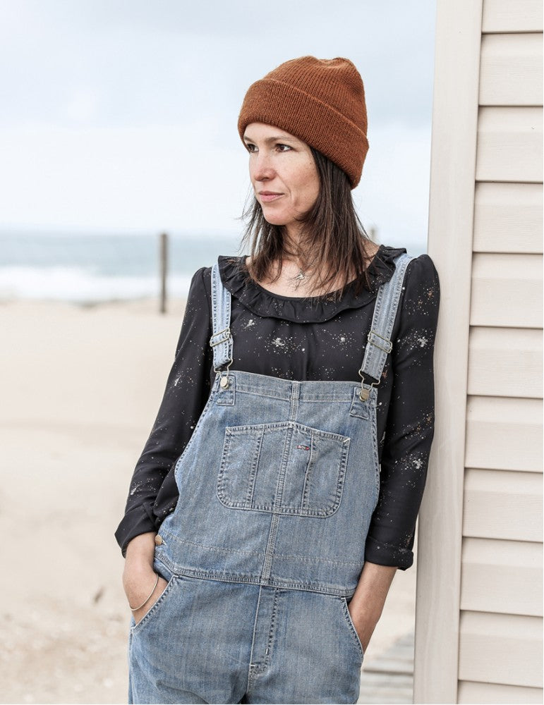 Woman wearing the Jenna Blouse sewing pattern from Atelier Scämmit on The Fold Line. A blouse pattern made in batiste, crepe, double gauze or light denim fabrics, featuring a round neckline with flounce and sleeves that are slightly gathered at the should