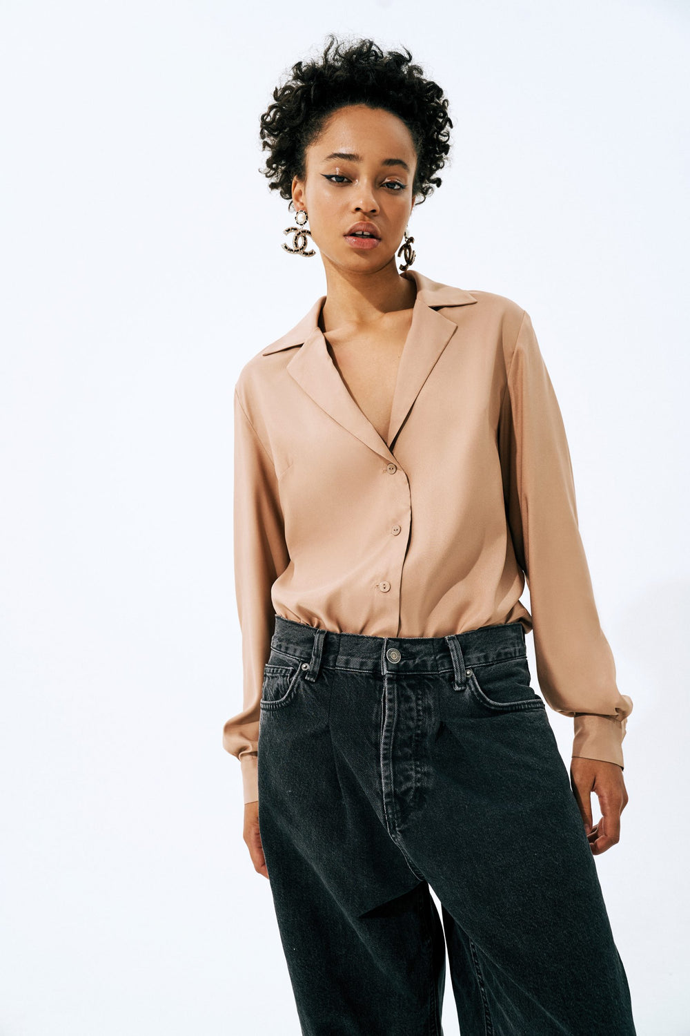 Woman wearing the Jenna Blouse sewing pattern from Vikisews on The Fold Line. A blouse pattern made in silk, silk velvet, challis or modal fabrics, featuring a loose-fit, straight silhouette, V-neck, bust darts, notched collar with stand, dropped shoulder