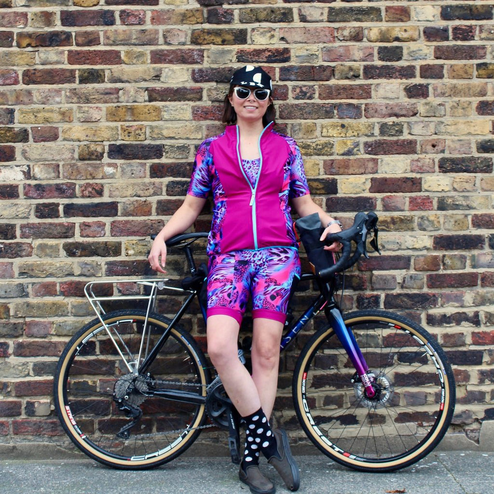 Woman wearing the Rouleur Leggings sewing pattern from Fehr Trade on The Fold Line. A leggings pattern made in lycra fabric, featuring a wide waistband, two side pockets, banded shorts hem, and stretchy cargo pockets.