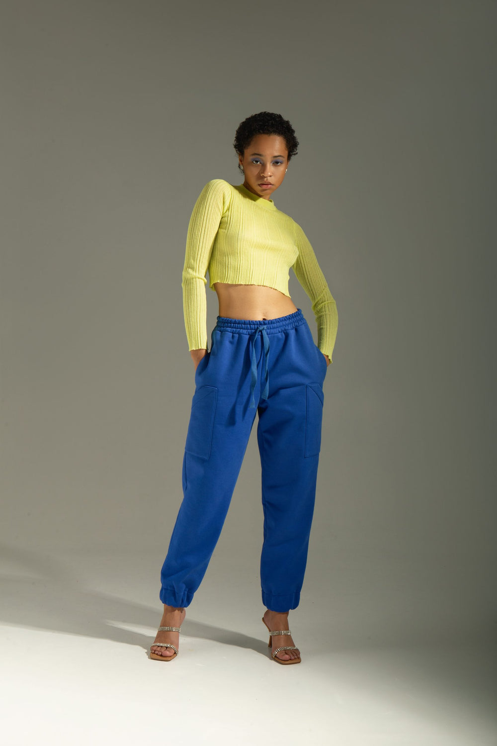 Woman wearing the Joanne Pants sewing pattern from Vikisews on The Fold Line. A jogger trouser pattern made in sweatshirt fleece, thick French terry, or jersey fabrics, featuring a loose-fit, straight-cut leg, elasticated waistband with twill tape drawstr