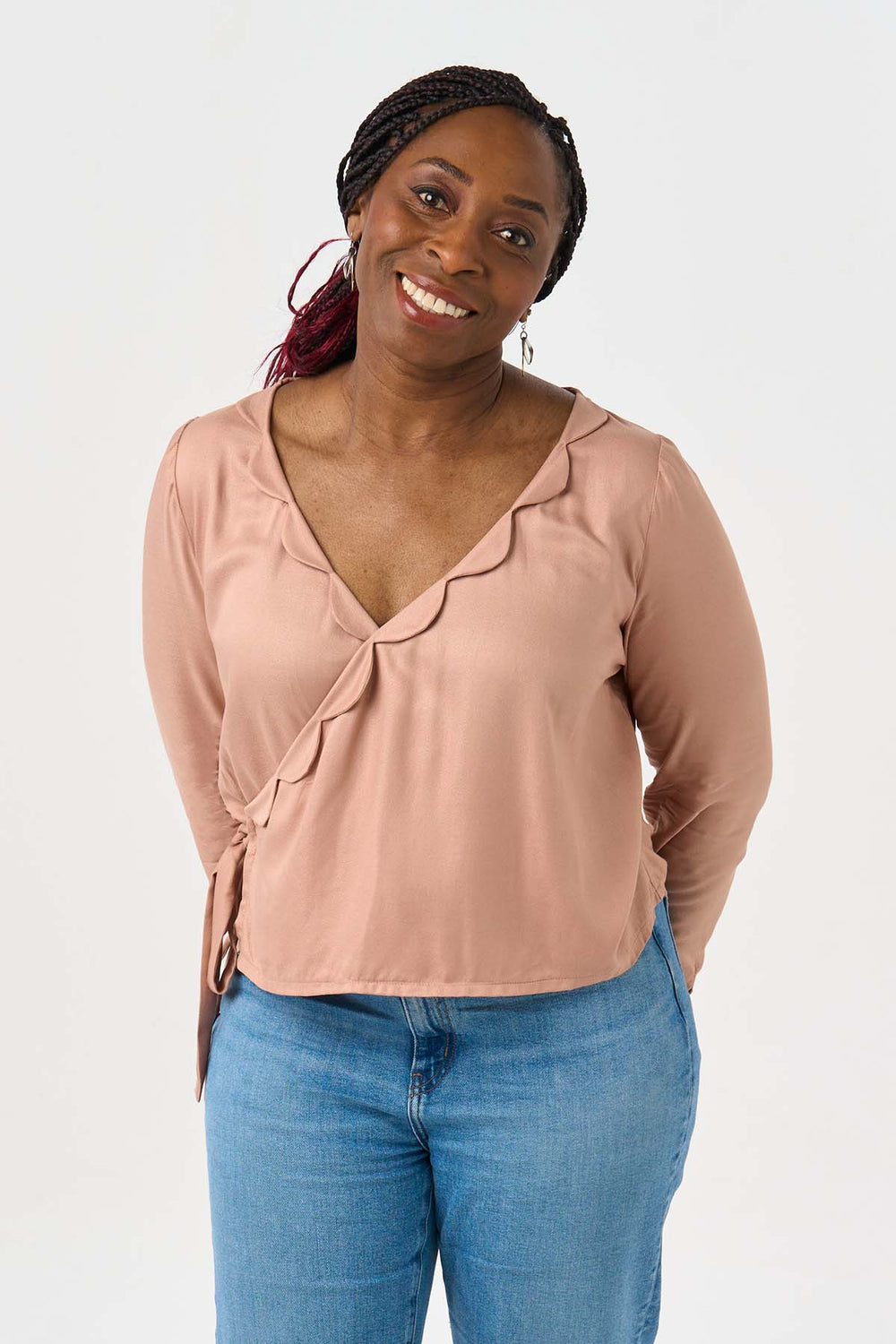Woman wearing the Josephine Blouse sewing pattern from Sew Over It on The Fold Line. A wrap blouse pattern made in rayon challis, viscose, charmeuse, sandwashed silk and crepe de chine fabrics, featuring a relaxed fit, deep V-neck with scalloped edges, si