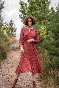 Woman wearing the Josephine Dress sewing pattern from Fibre Mood on The Fold Line. A dress pattern made in viscose (crepe), polyester (crepe), lyocell, seersucker, double gauze, crepon, broderie anglaise or poplin fabrics, featuring a jewel neck with V-sh