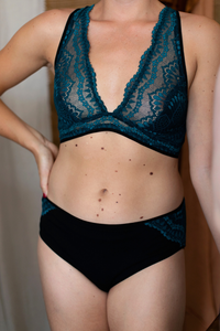Woman wearing the Josie Bra and Pants sewing pattern from Made My Wardrobe on The Fold Line. A bra and pants pattern made in medium weight knit fabrics, featuring a bra with cross back straps, underband, hook and eye closure. The classic briefs have full 