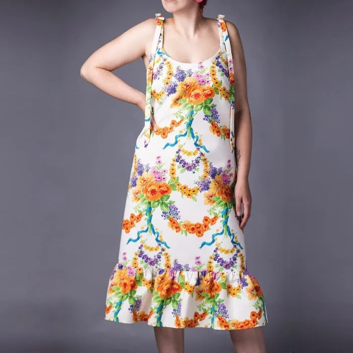 Woman wearing the Joy Dress sewing pattern from Maven Patterns on The Fold Line. A sun dress pattern made in crepe de chine, bamboo silk, viscose, rayon, chambray, linen, cotton lawn or lighter weight denim fabrics, featuring a slim A-line shape with rela