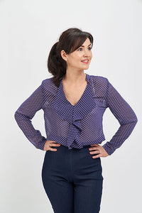Woman wearing the Juliette Blouse sewing pattern from Sew Over It on The Fold Line. A blouse pattern made in crepe de chine, satin, sandwashed silk, lightweight crepes and rayon fabrics, featuring a stand collar, front frill, dropped shoulders, long sleev