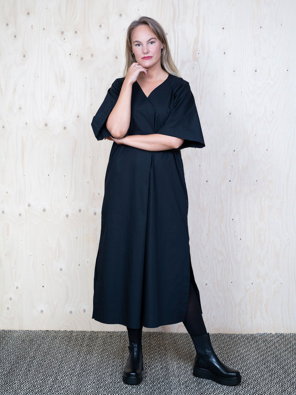 Woman wearing the Kaftan Dress sewing pattern from The Assembly Line on The Fold Line. A dress pattern made in cotton, silk, linen, crepe de chine or tencel fabrics, featuring a relaxed fit, elbow length raglan sleeves, overlap V-neck which creates a plea