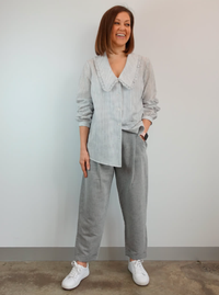 Woman wearing the Billie Woven Pant sewing pattern from Style Arc on The Fold Line. A trouser pattern made in crepe, fine wool or tencel fabrics, featuring an ankle-length with cuffs, tailored style, shaped waistband that sits on the natural waist, front 