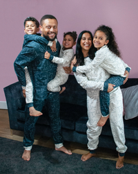 Man, Woman and Children wearing the Family Perri PJs sewing pattern from Pattern Paper Scissors on The Fold Line. A pyjamas pattern made in jersey or viscose jersey fabrics, featuring a round neck top with full length sleeve and cuff, trousers have full l