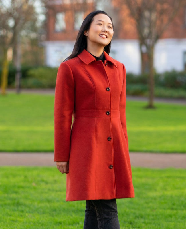 Women wearing the Lagan Coat sewing pattern from Itch to Stitch on The Fold Line. A coat pattern made in woollens, boiled wool, non-stretch fleece or gabardine fabrics, featuring a button front fastening, shoulder yokes, waistband, standard collar with co