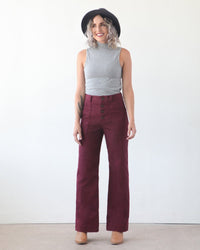 Woman wearing the Lander Pant sewing pattern by True Bias. A trouser pattern made in twill, linen, corduroy or denim fabric featuring a high waist, button fly, front and back patch pockets and a straight fit through the leg.