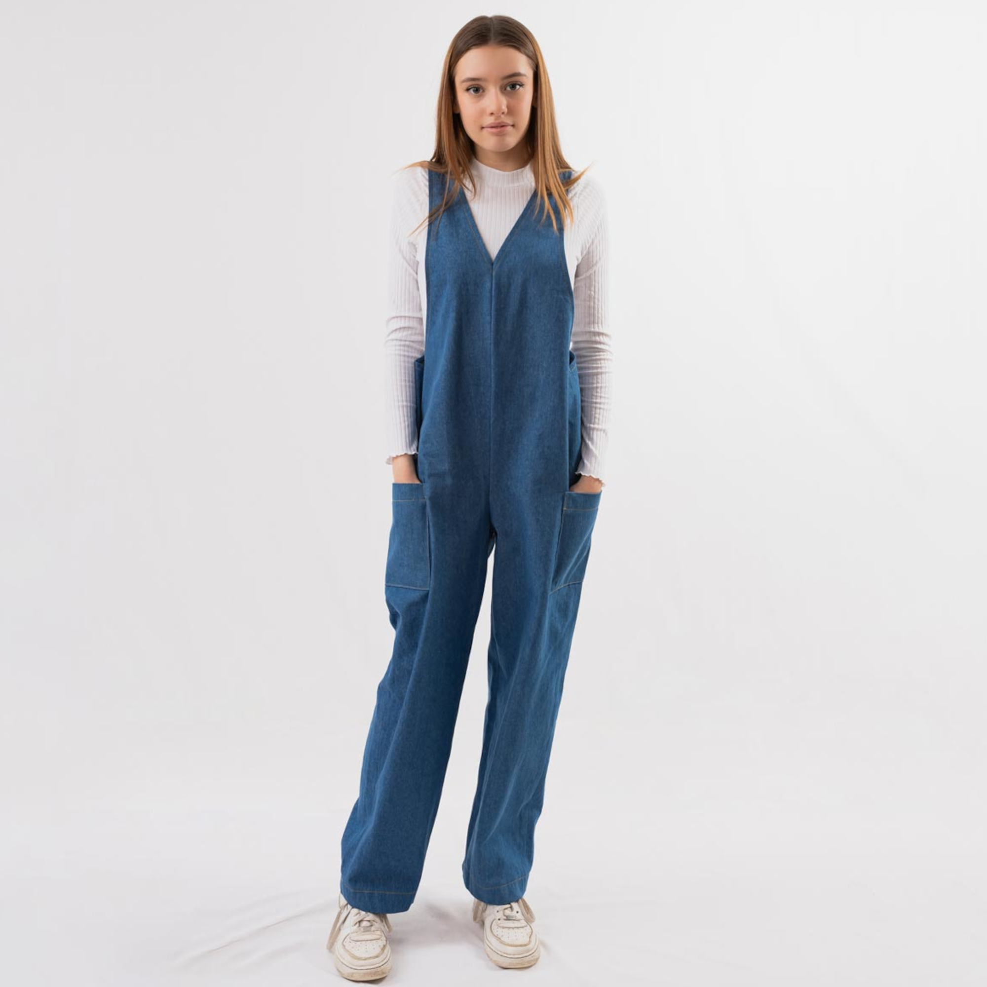 Women wearing the Lauren Dungarees sewing pattern by Fieldwork Patterns. A dungaree pattern made in denim, corduroy, cotton, twill or linen fabrics, featuring a loose fit, large patch pockets and keyhole cross over back detail.