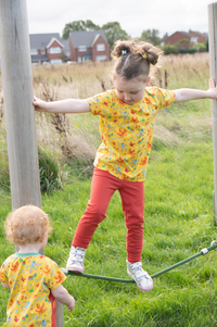 Children wearing the Baby/Child Lee T-shirt sewing pattern by Bobbins and Buttons. A T-shirt pattern made in light to medium weight stretch jersey fabrics, featuring a crew neck and short sleeves.