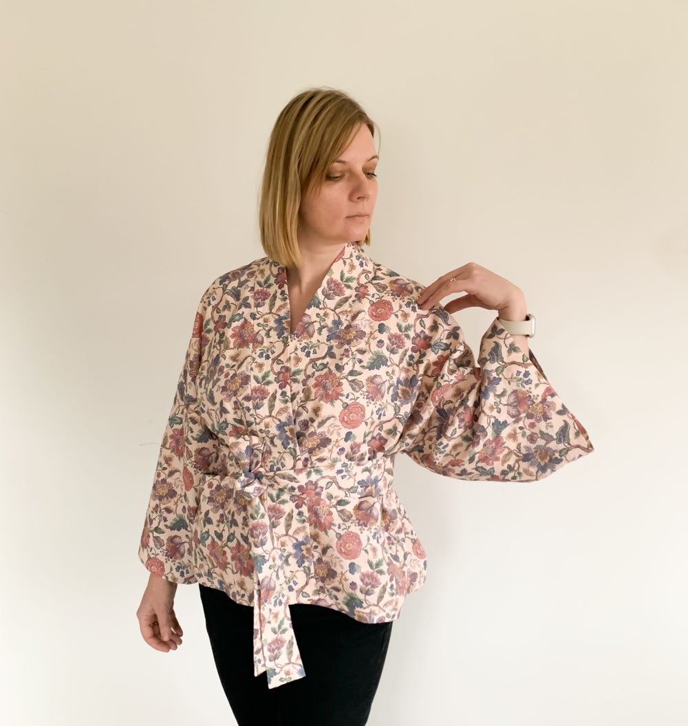 Woman wearing the Leon Jacket sewing pattern from Lenaline Patterns on The Fold Line. A wrap jacket pattern made in cotton, silk, linen, viscose, jacquard, or quilted fabrics, featuring a loose fit, patch pockets, full length loose sleeves and self-fabric