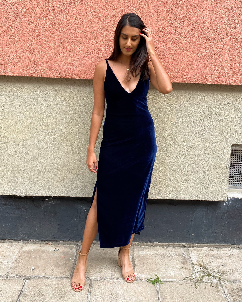 Woman wearing the Leona Dress sewing pattern from Tammy Handmade on The Fold Line. A slip-on, sleeveless dress pattern made in 4-way stretch fabric such as jersey, crepe jersey, stretch velvet or scuba fabrics, featuring a figure-hugging silhouette, deep 