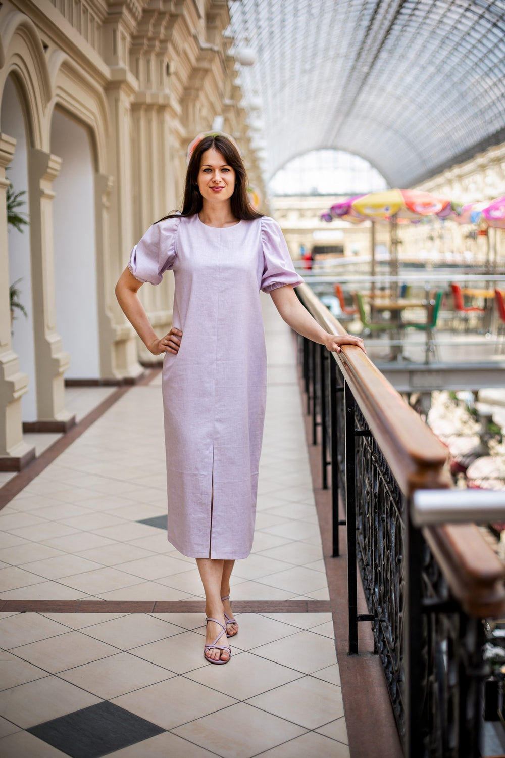 Woman wearing the Lesia Dress sewing pattern from Kates Sewing Patterns on The Fold Line. A dress pattern made in linen or cotton fabrics, featuring a loose, straight-cut fit, midi length, centre front hem slit, back neckline button closure and voluminous