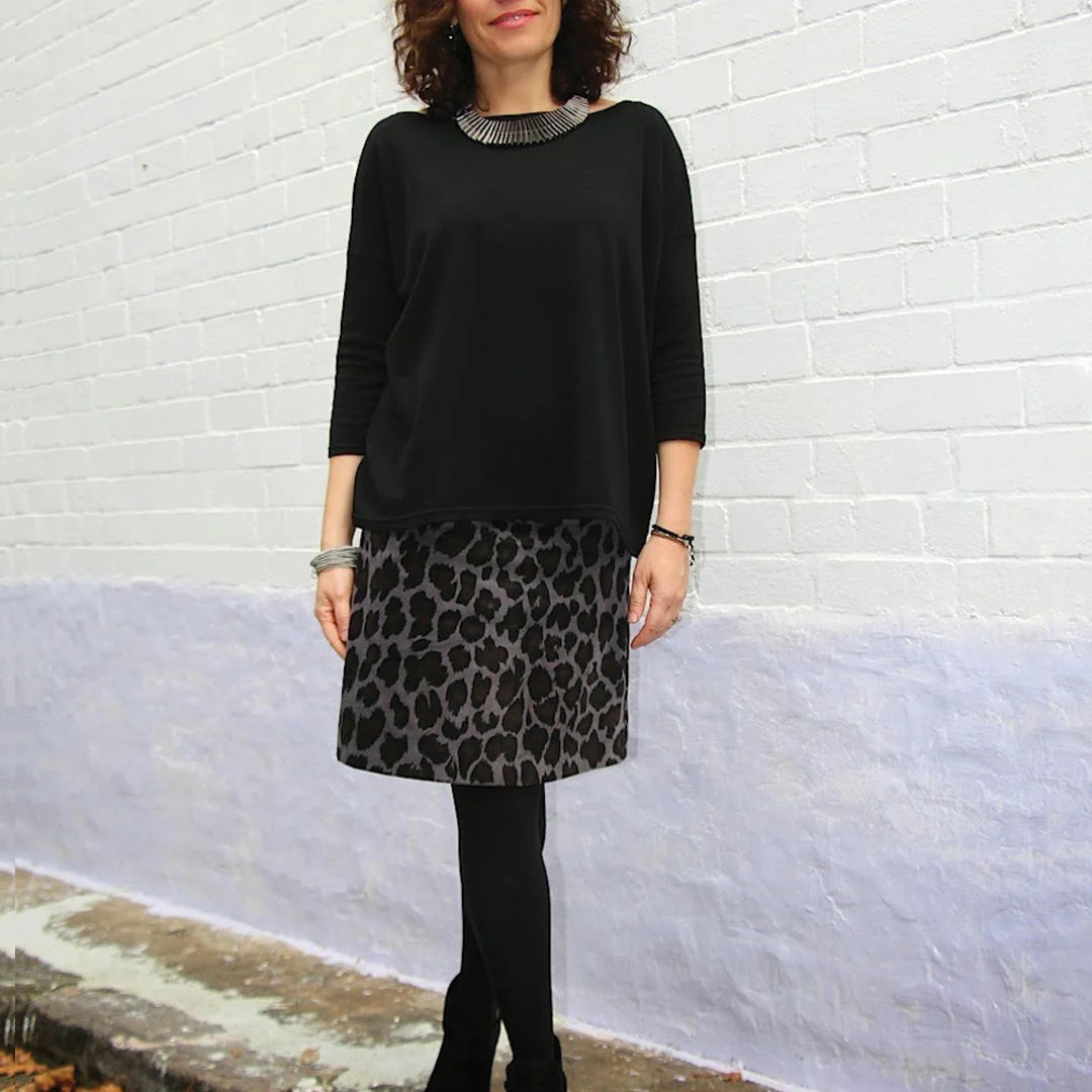 Woman wearing the Libby A-line Skirt sewing pattern Tessuti Fabrics on The Fold Line. A skirt pattern made in cotton, wool, linen or silk fabrics, featuring an A-line silhouette, above knee length, side invisible zipper, and back darts.