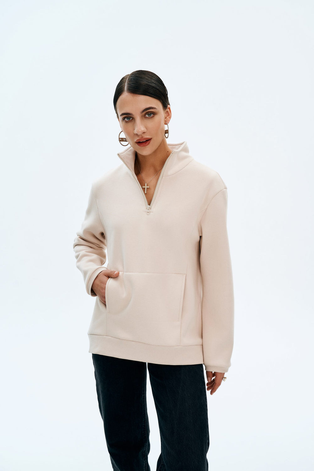 Woman wearing the Lindsey Hoodie sewing pattern from Vikisews on The Fold Line. A hoodie pattern made in French terry, sweatshirt fleece or neoprene fabrics, featuring a loose-fit with trapeze silhouette, in-seam pockets, back shaped yoke, dropped shoulde