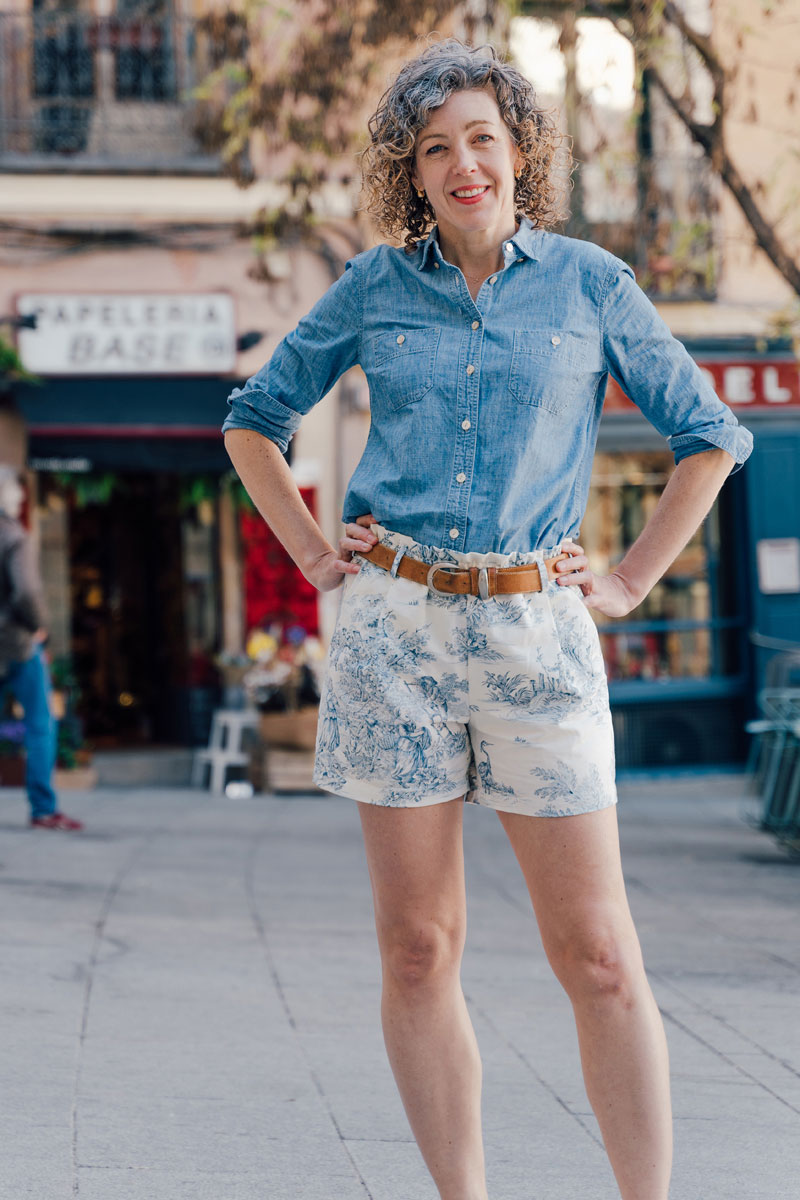 Woman wearing the Lisboa Walking Shorts sewing pattern from Liesl + Co on The Fold Line. A shorts pattern made in cotton poplin, twill, canvas, linen, wool suiting or wool flannel fabrics, featuring a pull-on style, elastic paper-bag waist, belt loops, fr