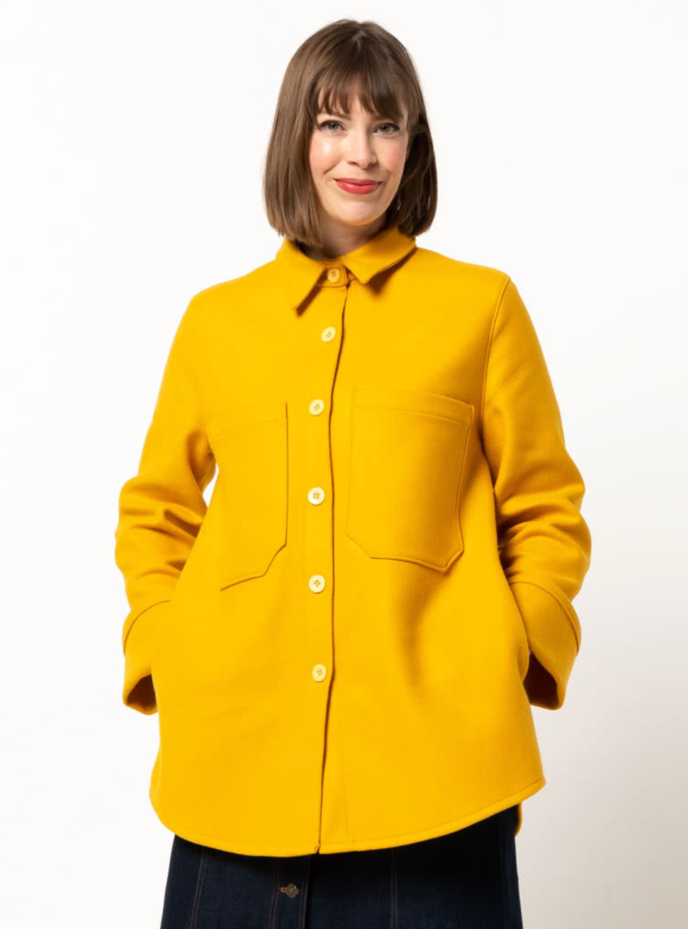 Woman wearing the Logan Shacket sewing pattern from Style Arc on The Fold Line. A shacket pattern made in boiled wool, denim, corduroy, linen, or flannelette fabrics, featuring an oversized fit, slightly dropped shoulders, two-piece shirt collar, button f