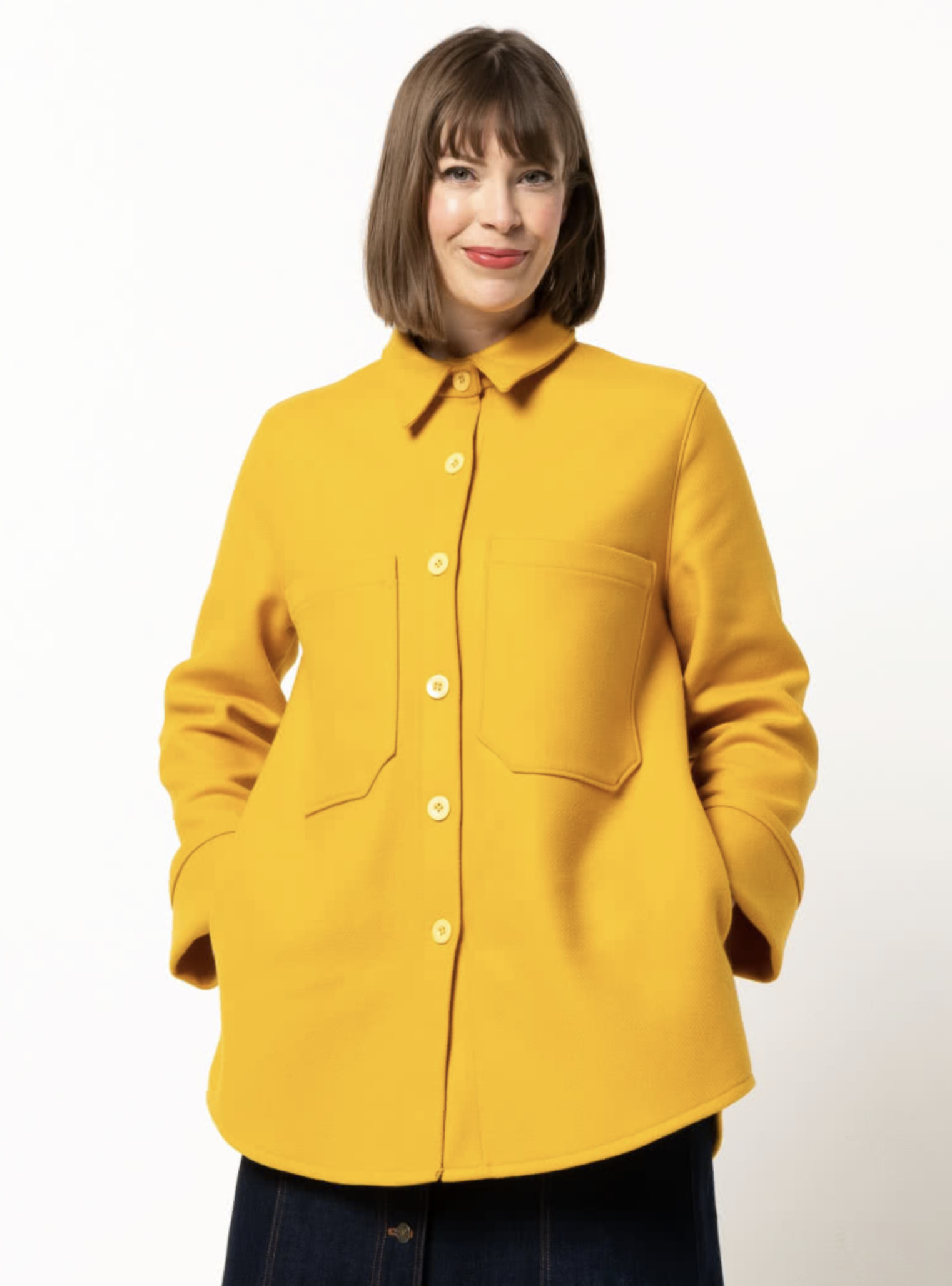 Woman wearing the Logan Shacket sewing pattern from Style Arc on The Fold Line. A shacket pattern made in boiled wool, denim, corduroy, linen, or flannelette fabrics, featuring an oversized fit, slightly dropped shoulders, two-piece shirt collar, button f