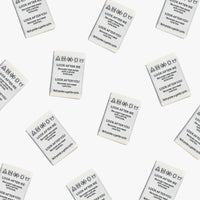 Photo showing 'Look After Me, Look After You' Woven Labels from Kylie & The Machine on The Fold Line. A washable, durable and non-scratchy fabric label featuring an ivory background with black text, they are all ready to be sewn into your handmade clothes