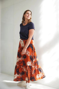 Woman wearing the Lottie Skirt sewing pattern from Atelier Jupe on The Fold Line. A skirt pattern made in viscose or tencel fabrics, featuring a bottom ruffle, elasticated back waistband and maxi length.