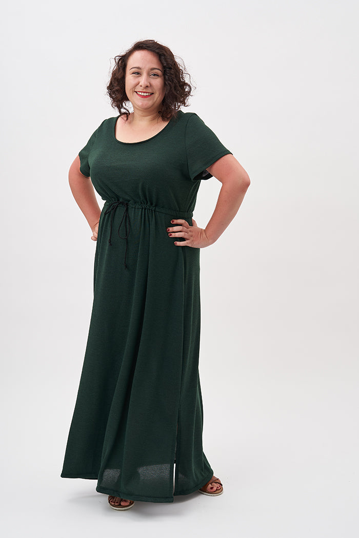 Woman wearing the Lucy T-shirt Dress sewing pattern from Sew Over It on The Fold Line. A dress pattern made in viscose or cotton jersey fabrics, featuring a scoop neckline, short sleeves, loose-fitting silhouette, maxi length hem, drawstring waist cord an