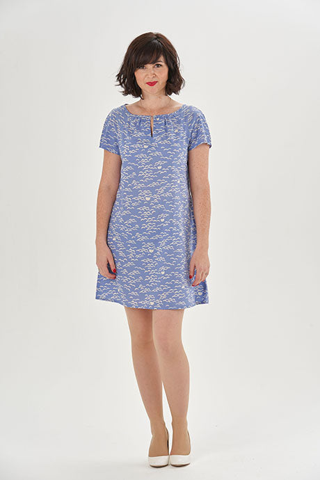 Woman wearing the Lulu Dress sewing pattern from Sew Over It on The Fold Line. A dress pattern made in cotton, cotton lawn, rayon, or crepe fabric, featuring a loose, slightly A-line fit, raglan sleeves, and a gathered neckline with a keyhole detail.