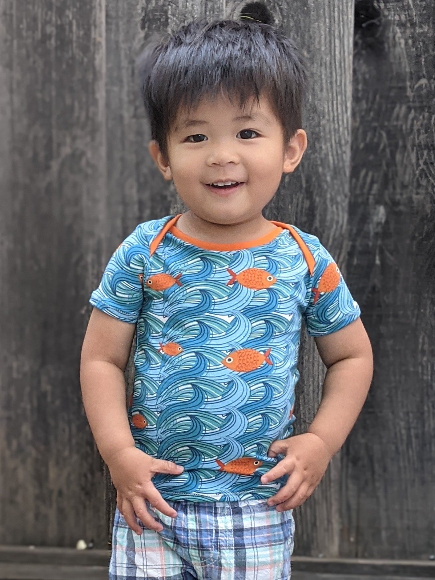 Child wearing the Free Baby/Child Lunar T-shirt sewing pattern from Waves & Wild on The Fold Line. A Tee pattern made in cotton/Lycra jersey fabrics, featuring an envelope neck, short sleeves and slim fit.