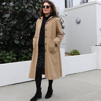 Woman wearing the Melbourne Trench Coat sewing pattern from Tessuti Fabrics on The Fold Line. A trench coat pattern made in water-resistant polyester, nylon, medium weight wool, wool crepe, firm cotton, or cotton blends fabrics, featuring a button front c