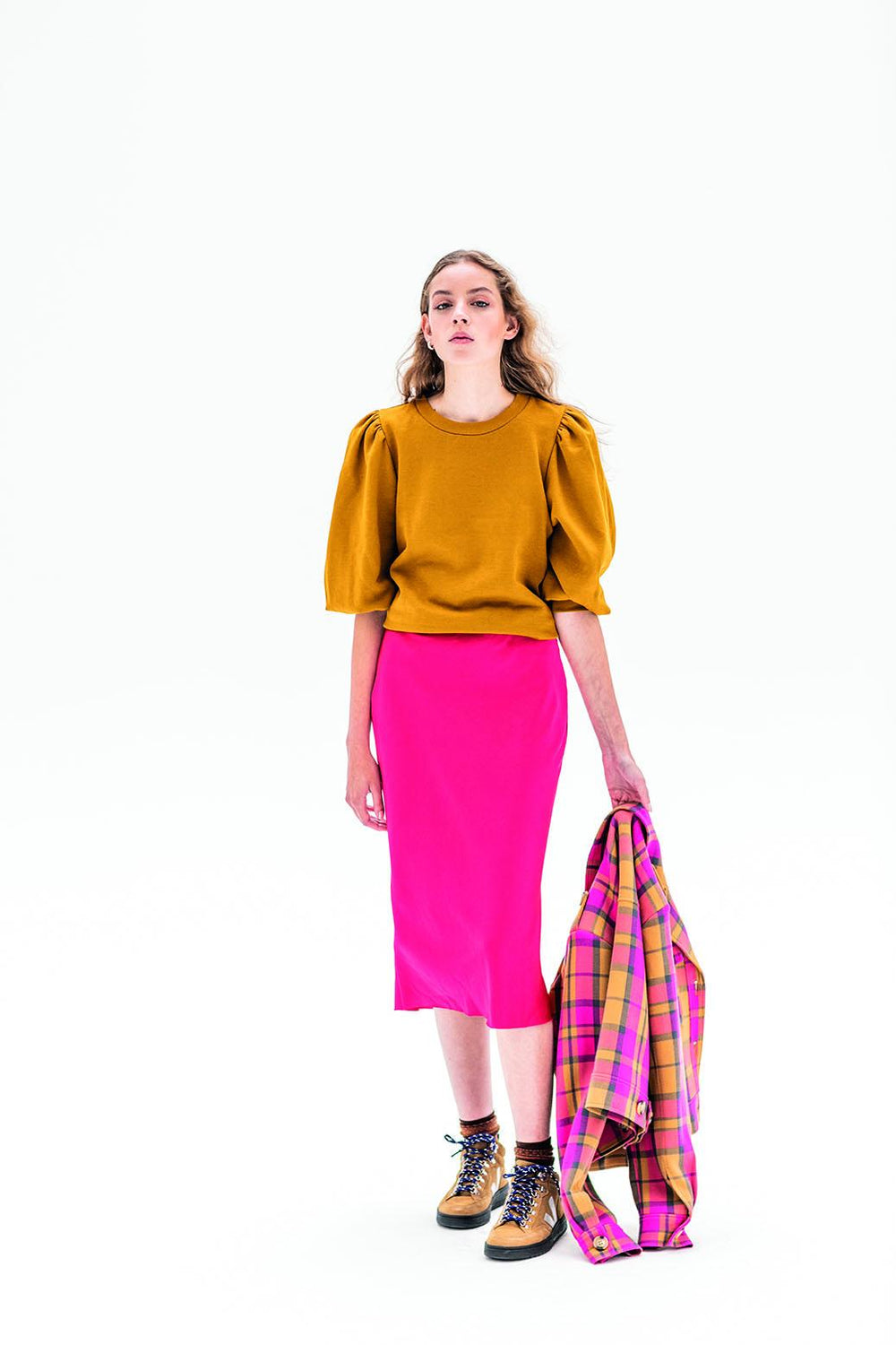 Woman wearing the Madeline Skirt sewing pattern from Fibre Mood on The Fold Line. A fitted skirt pattern made in silky satin fabrics, featuring a bias cut, invisible zip and midi length.