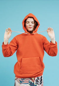 Women wearing the Unisex Maggi Sweater sewing pattern from Melilot on The Fold Line. A hoodie pattern made in medium to heavyweight weight knit fabrics, featuring a pattern to add a hood and kangaroo pocket to the Maggi Sweater.