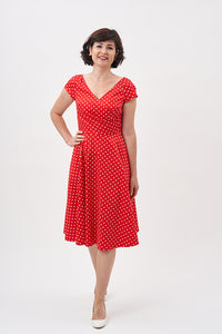 Woman wearing the Maisie Dress sewing pattern from Sew Over It on The Fold Line. A fit and flare 1950’s dress pattern made in cotton, cottons, linen, chambray or stable crepes fabrics, featuring bust darts, fixed wrap front which pleats into the side seam